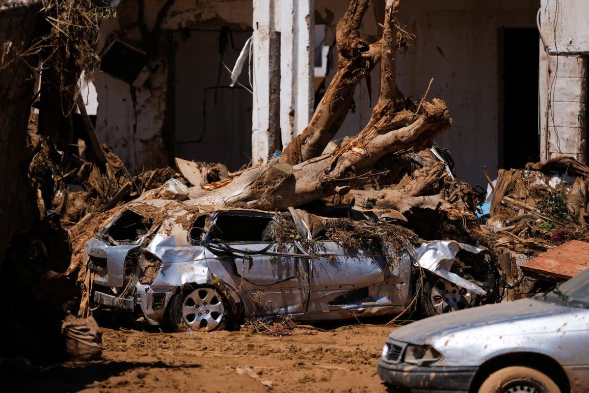 Flood-damaged cars and homes in the Libyan city of Derna  (Reuters)