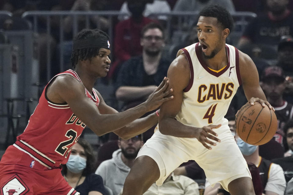 Cleveland Cavaliers' Evan Mobley (4) drives against Chicago Bulls' Alize Johnson (22) in the first half of an NBA preseason basketball game, Sunday, Oct. 10, 2021, in Cleveland. (AP Photo/Tony Dejak)