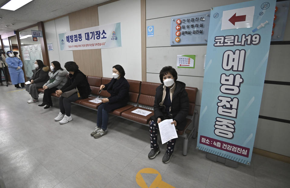 Nursing home workers wait to receive the first dose of the AstraZeneca COVID-19 vaccine at a health care center in Seoul Friday, Feb. 26, 2021. South Korea on Friday administered its first available shots of coronavirus vaccines to people at long-term care facilities, launching a mass immunization campaign that health authorities hope will restore some level of normalcy by the end of the year. (Jung Yeon-je /Pool Photo via AP)