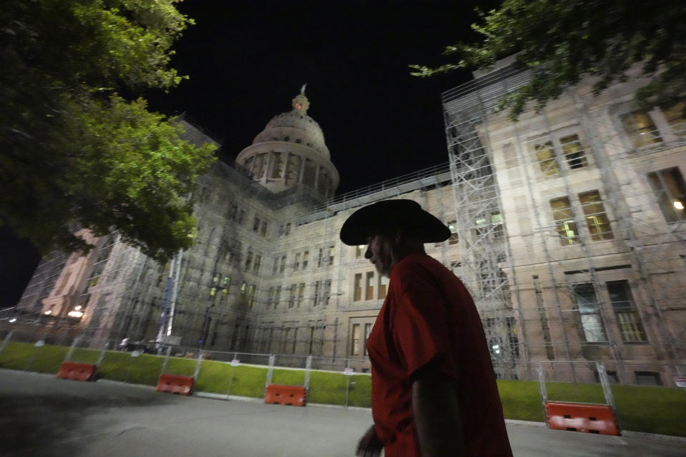 Kyle Simms of McKinney, Texas, walks to the Texas State Capital early in the morning to show his support for Texas Attorney General Ken Paxton before his impeachment trial starts in Austin, Tuesday, Sept. 5, 2023. (AP Photo/LM Otero)