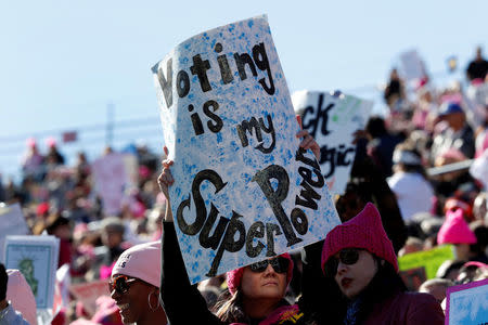 A woman holds up a sign during the Women's March rally in Las Vegas, Nevada, U.S. January 21, 2018. REUTERS/Steve Marcus