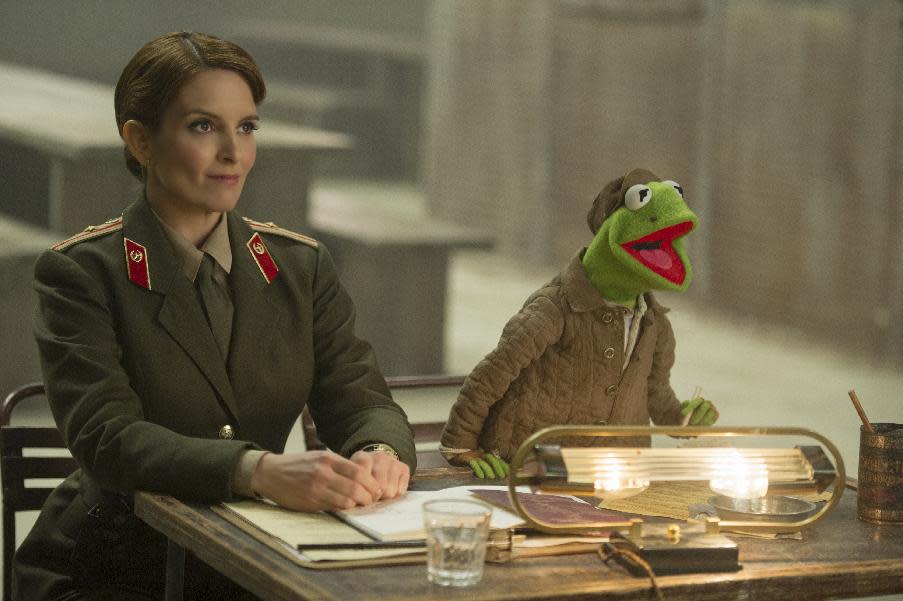 This image released by Disney shows Tina Fey, left, and Kermit the Frog in a scene from "Muppets Most Wanted." (AP Photo/Disney, Jay Maidment)