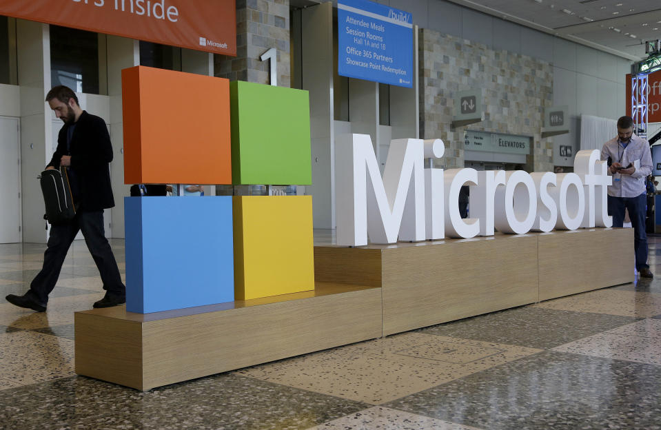 FILE - A man walks past a Microsoft sign set up for the Microsoft BUILD conference, April 28, 2015, at Moscone Center in San Francisco. Microsoft will pay a fine of $20 million to settle Federal Trade Commission charges that it illegally collected and retained the data of children who signed up to use its Xbox video game console. (AP Photo/Jeff Chiu, File)