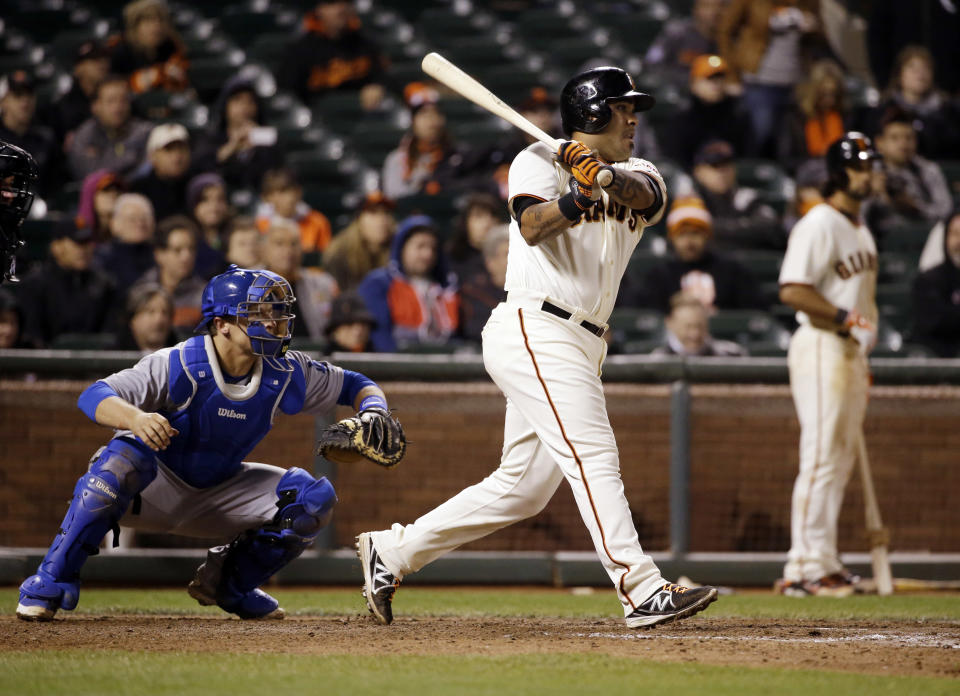 San Francisco Giants' Hector Sanchez singles in the game-winning run during the 12th inning of a baseball game against the Los Angeles Dodgers on Wednesday, April 16, 2014, in San Francisco. San Francisco won 3-2. (AP Photo/Marcio Jose Sanchez)