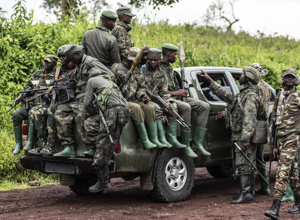 FILE - M23 rebels load a pickup truck in Kibumba, in the eastern of Democratic Republic of Congo, Dec. 23, 2022. Aid organisations fear a new humanitarian crisis in the restive eastern Congo region, where the renowned armed rebel group M23 is in the midst of a new advance that threatens to cut off a major city and leave millions of people struggling for food and medical help.(AP Photo/Moses Sawasawa, File)