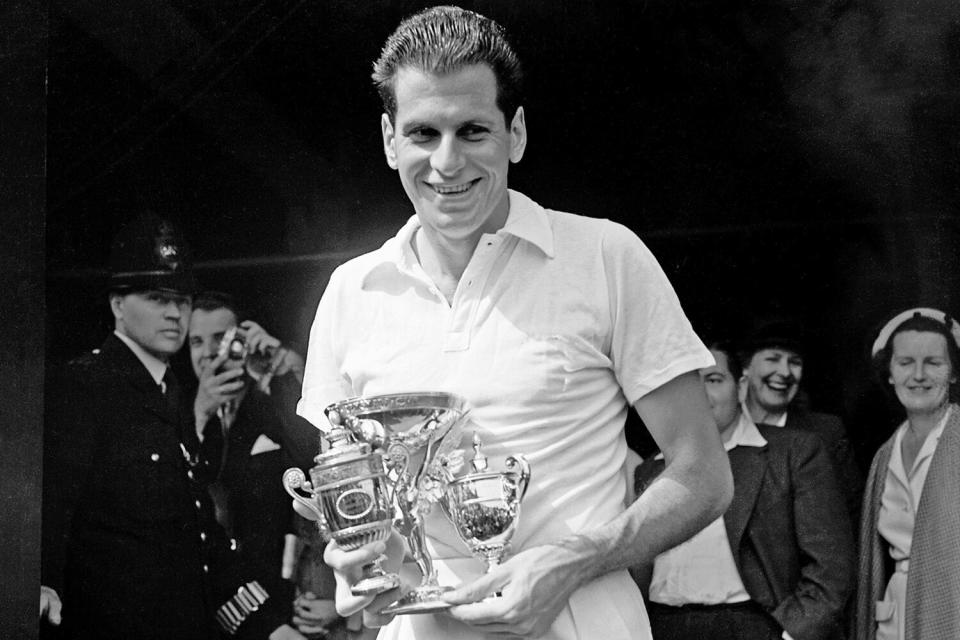 Men's singles champion Dick Savitt with the trophy after his straight sets win (Photo by S&G/PA Images via Getty Images)