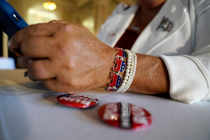 Cobb County, Ga., GOP chairperson Salleigh Grubbs looks at her phone during an election night watch party for U.S. Senate candidate Herschel Walker, Tuesday, May 24, 2022, in Atlanta. (AP Photo/Brynn Anderson)