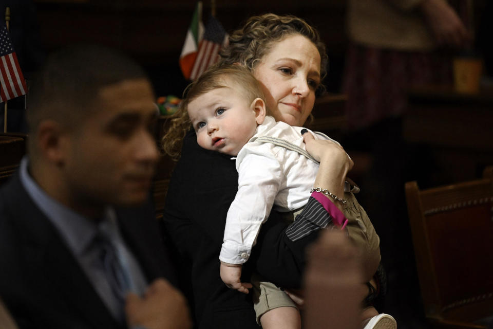 State Rep. Aimee Berger-Girvalo, D-Ridgefield, holds Charlie Parker, son of state Rep. John-Michael Parker during the opening session of the legislature at the State Capitol, Wednesday, Feb. 7, 2024, in Hartford, Conn. (AP Photo/Jessica Hill)