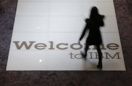 A woman walks over a welcoming sign at the booth of IBM at the CeBIT trade fair in Hanover March 15, 2015. REUTERS/Morris Mac Matzen