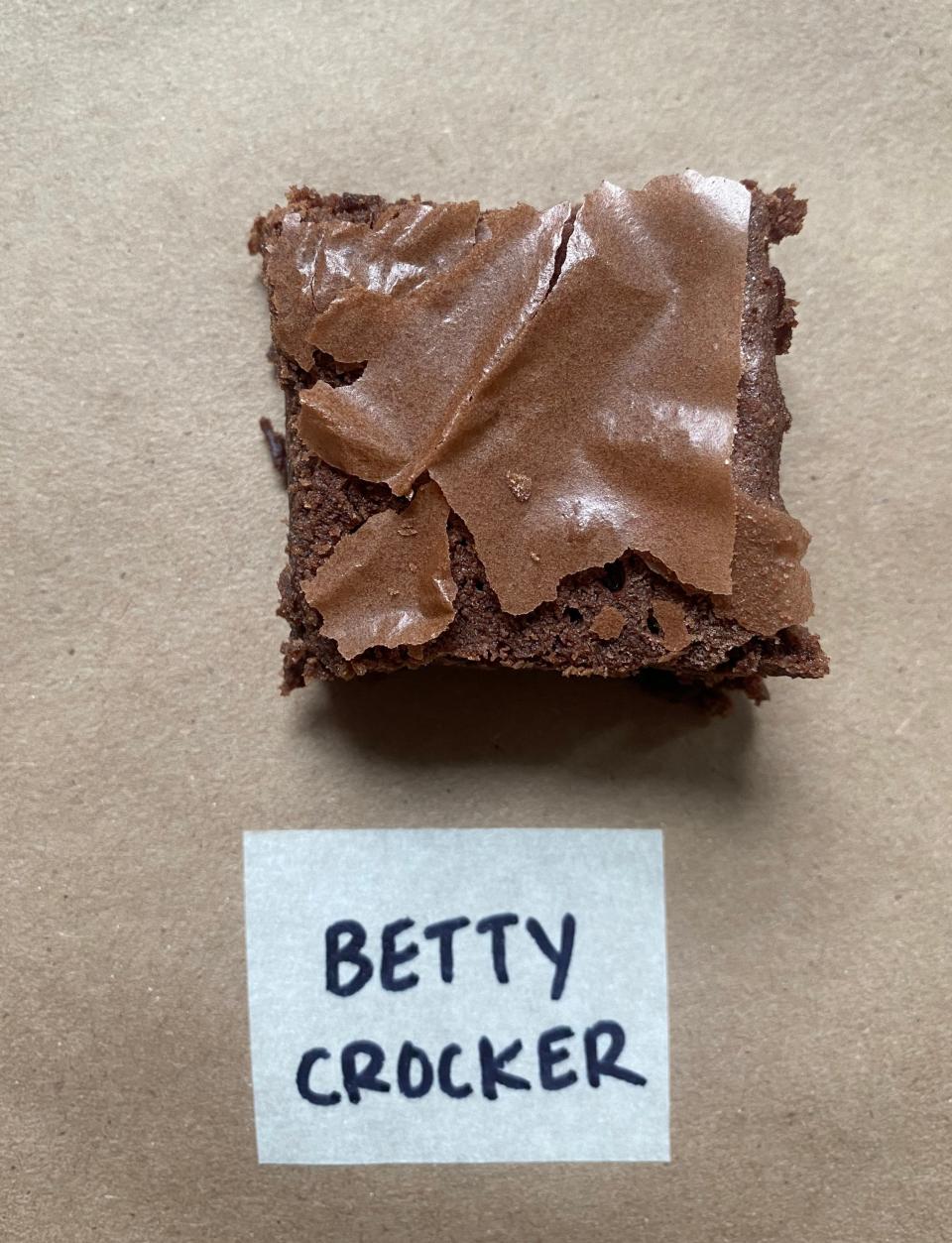 A close-up of a brownie with a 'Betty Crocker' label in front