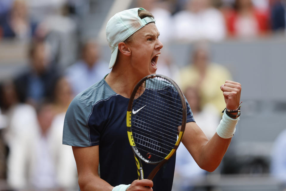 Denmark's Holger Rune clenches his fist after scoring a point against Greece's Stefanos Tsitsipas during their fourth round match at the French Open tennis tournament in Roland Garros stadium in Paris, France, Monday, May 30, 2022. (AP Photo/Jean-Francois Badias)