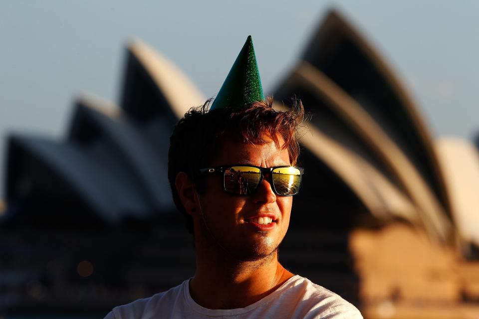 SYDNEY, AUSTRALIA - DECEMBER 31: A man wearing a party hat waits in anticipation of New Years Eve celebrations on Sydney Harbour on December 31, 2012 in Sydney, Australia. (Photo by Brendon Thorne/Getty Images)