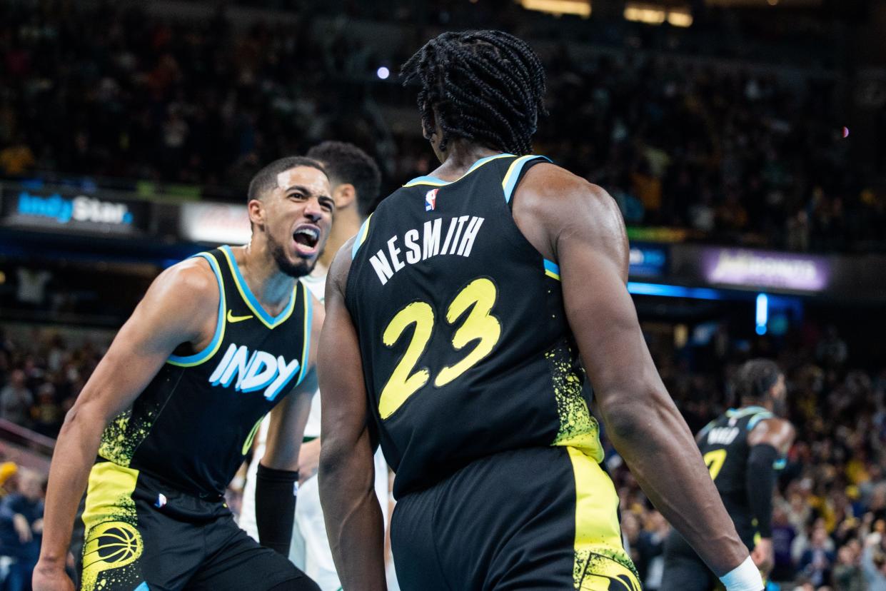 Dec 4, 2023; Indianapolis, Indiana, USA; Indiana Pacers forward Aaron Nesmith (23) celebrates a made basket with guard Tyrese Haliburton (0) in the second half against the Boston Celtics at Gainbridge Fieldhouse. Mandatory Credit: Trevor Ruszkowski-USA TODAY Sports