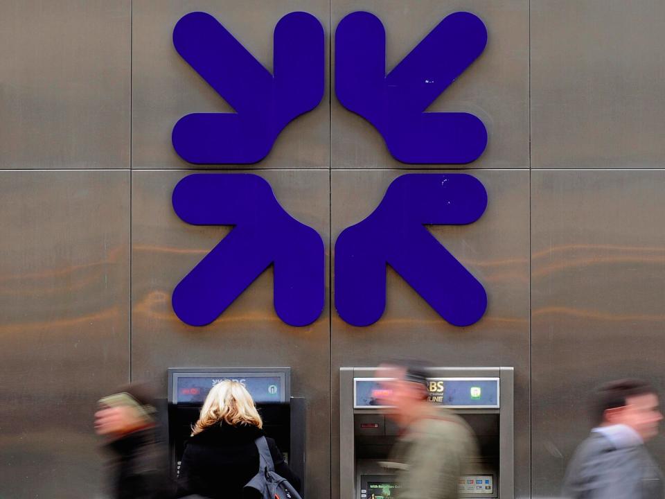 A woman uses an ATM at a Royal Bank of Scotland (RBS) branch in London, Britain, February 25, 2010.