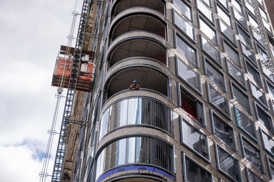 A photo of a worker peering out from a worksite in lower Manhattan moments after New York City and parts of New Jersey experienced a 4.8 magnitude earthquake on April 5, 2024 in New York City. 