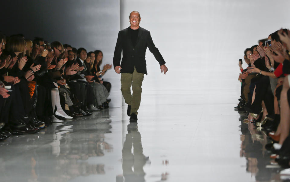 Fashion designer Michael Kors reacts to applause after showing his Fall 2013 collection on Wednesday, Feb. 13, 2013 in New York. (AP Photo/Bebeto Matthews)