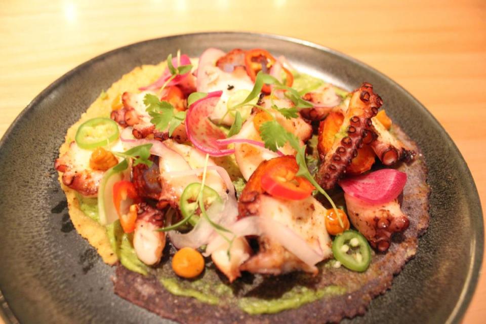 Memela de Pulpo, featuring grilled octopus, guajillo chile ajo, guaje seed crema fresca, chapulines al adobo, and salsa verde cruda, the starter option in the Destiantion Oaxaca limited time menu at Toro Toro Fort Worth.