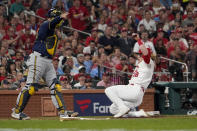 St. Louis Cardinals' Harrison Bader, right, scores past Milwaukee Brewers catcher Omar Narvaez during the fourth inning of a baseball game Tuesday, Sept. 28, 2021, in St. Louis. (AP Photo/Jeff Roberson)