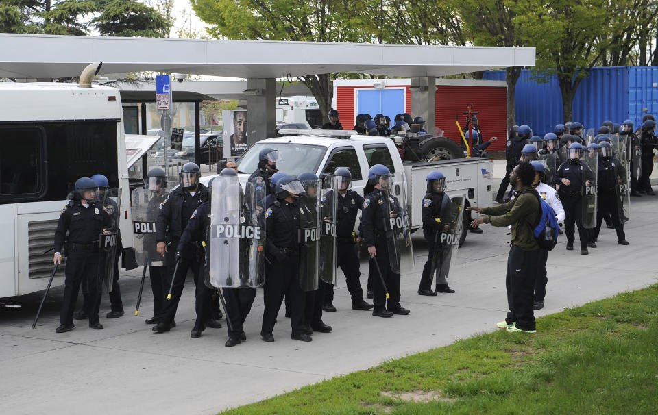 Police with shields face a man near the subway station at Mondawmin Mall in Baltimore, MD, USA, on Monday, April 27, 2015. People threw rocks at police and members of the media near the mall during riots Monday afternoon. Photo by Barbara Haddock Taylor/Baltimore Sun/TNS/ABACAPRESS.COM