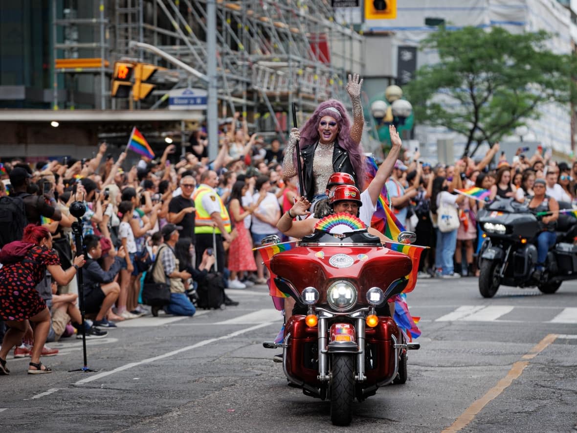 Participants on Yonge Street for the Pride parade on June 26, 2022. Organizers of Toronto's Pride festival say they're concerned about the cost of policing and insurance, which they say are dramatically increasing because of the risk of threats.   (Evan Mitsui/CBC - image credit)