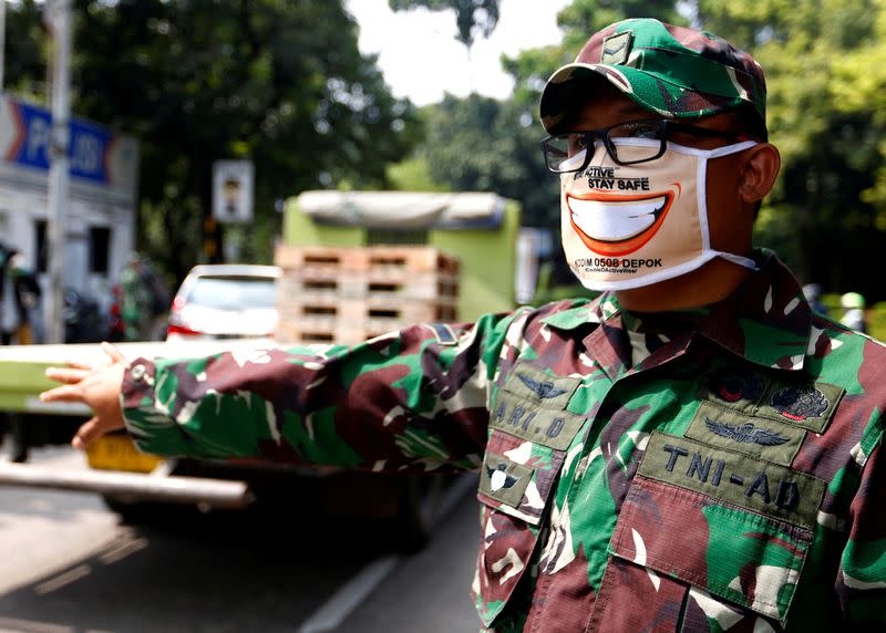 Indonesian National Armed Force personnel wears a face mask during large-scale social restrictions to prevent the spread of coronavirus disease (COVID-19) outbreak in Depok, on the outskirts of Jakarta