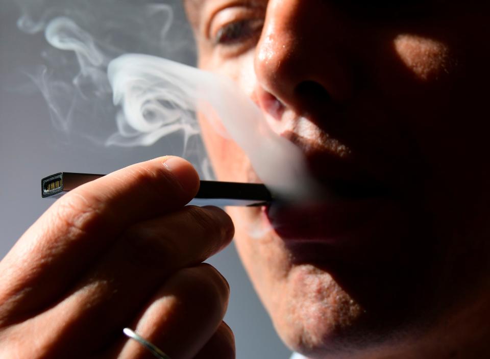 A man exhales from an electronic cigarette in Washington, DC, in October 2018.