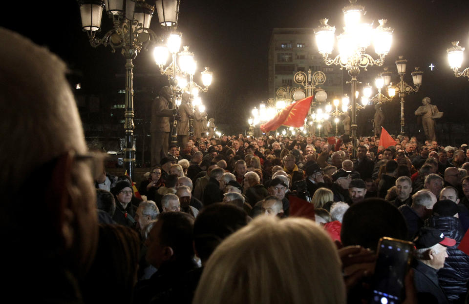 People gather for a protest march organized by the opposition conservative VMRO-DPMNE party, starting outside the Public Prosecutor's office and ending in front of the complex of national courts, in Skopje, North Macedonia, Tuesday, Feb. 25, 2020. Thousands of conservative opposition party supporters were marching in North Macedonia's capital Skopje late on Tuesday, accusing the outgoing leftist government for strongly influencing prosecution and court decisions. (AP Photo/Boris Grdanoski)