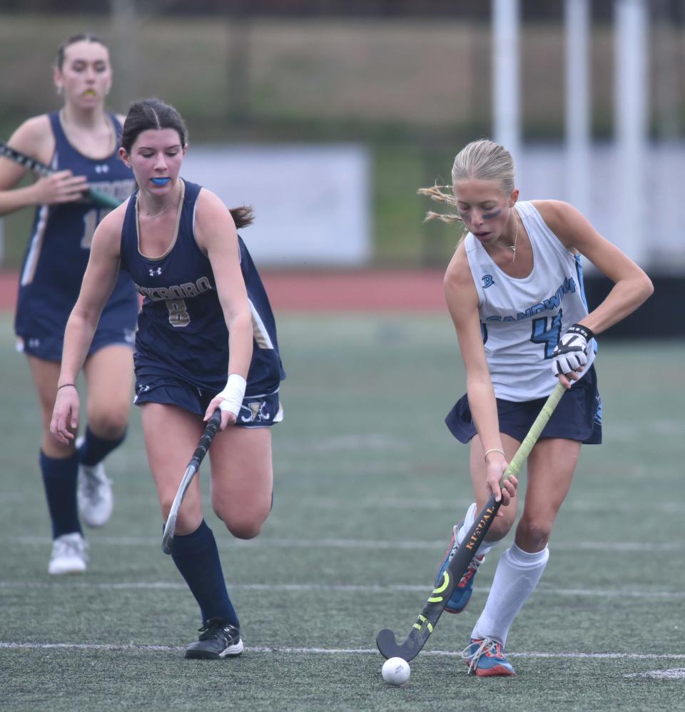 Sandwich's Sadie Clarkin, right, out paces Foxborough's Jacalyn Connors as Sandwich hosted Foxborough in tournament field hockey action on Friday afternoon. Sandwich went on to win in overtime, 2-1.
