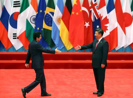 FILE PHOTO - Chinese President Xi Jinping welcomes Japanese Prime Minister Shinzo Abe to the G20 Summit in Hangzhou, Zhejiang province, China September 4, 2016. REUTERS/Damir Sagolj