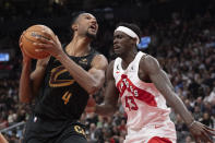 Cleveland Cavaliers' Evan Mobley (4) looks to shoot on Toronto Raptors' Pascal Siakam during second the second half of an NBA basketball game in Toronto, Monday, Nov. 28, 2022. (Chris Young/The Canadian Press via AP)