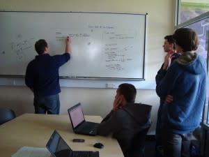 Man writing on whiteboard for clients