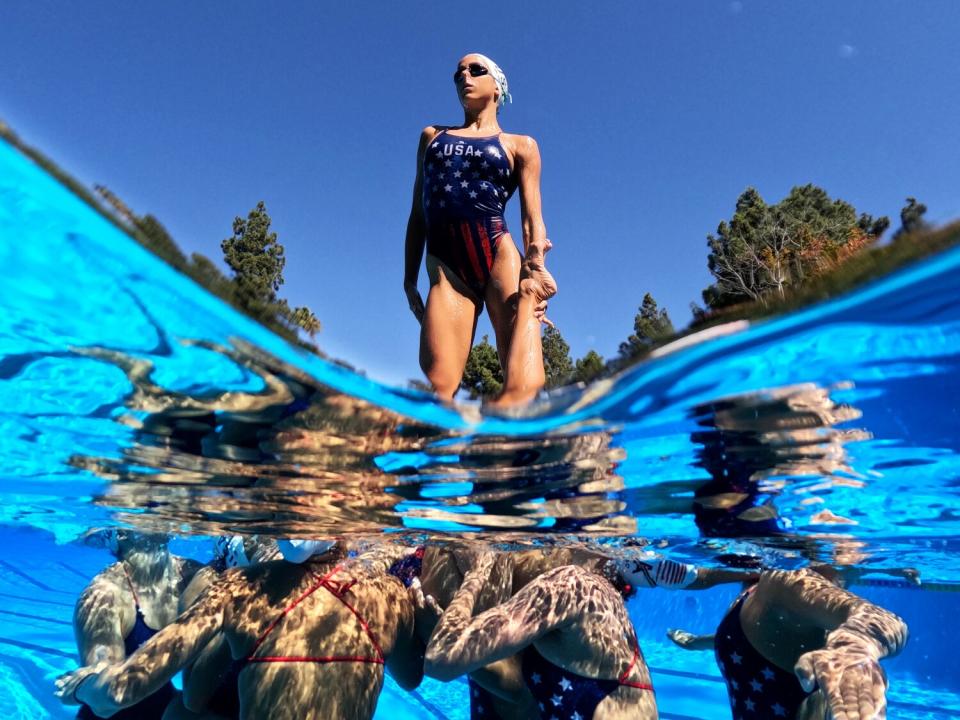 U.S. Artistic Swimming team member Elisa Brunel is lifted above the water during a recent practice at UCLA.