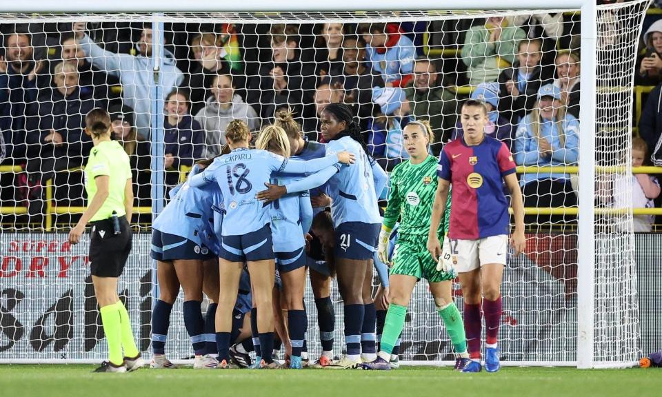 <span>Manchester City players huddle in delight after taking the lead against Barcelona.</span><span>Photograph: Adam Vaughan/EPA</span>