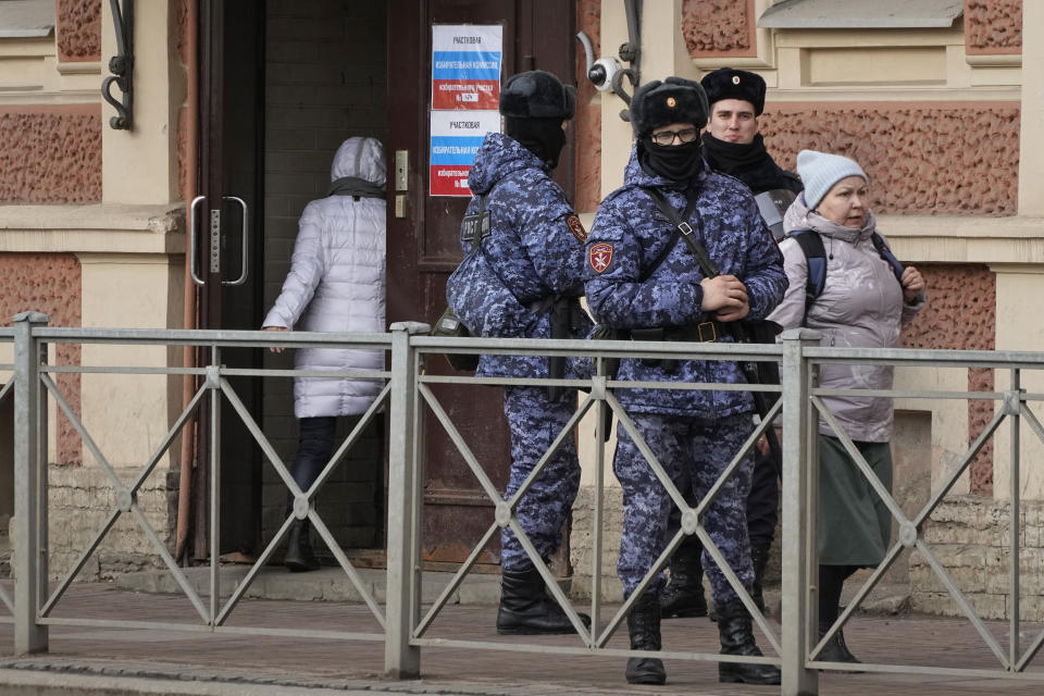 Russian Rosguardia (National Guard) servicemen stand guard at a pooling station during the presidential elections in St. Petersburg, Russia, Saturday, March 16, 2024. Voters in Russia are heading to the polls for a presidential election that is all but certain to extend President Vladimir Putin's rule after he clamped down on dissent. (AP Photo/Dmitri Lovetsky)