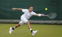 Austin Krajicek of the U.S. returns the ball to Belgium's Yannick Mertens during their singles match during the Wimbledon Tennis Championships qualifying rounds at the Bank of England Sports Centre in Roehampton, southwest London, Britain June 23, 2015. REUTERS/Suzanne Plunkett