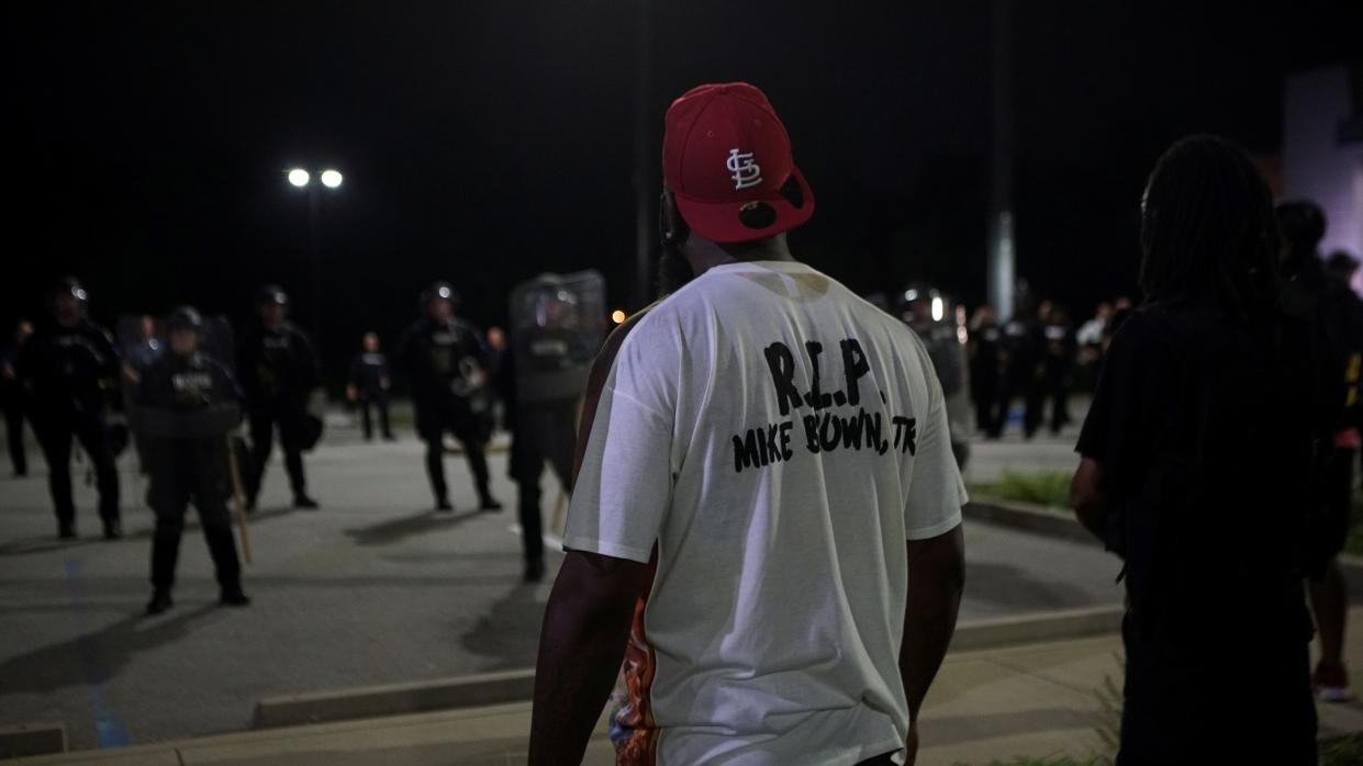 Michael Brown Sr. stands in front of the Ferguson Police officers during a 2020 protest marking six years since 18-year-old Michael Brown Jr. was shot dead by the police in Ferguson, Missouri.