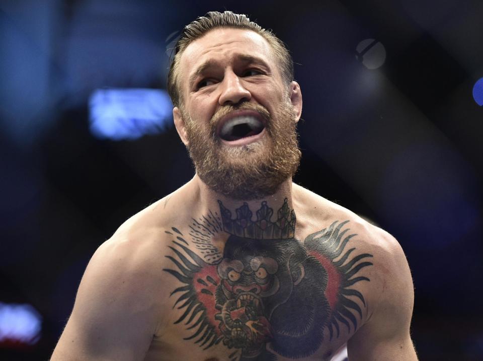 Conor McGregor celebrates his stunning victory: Getty