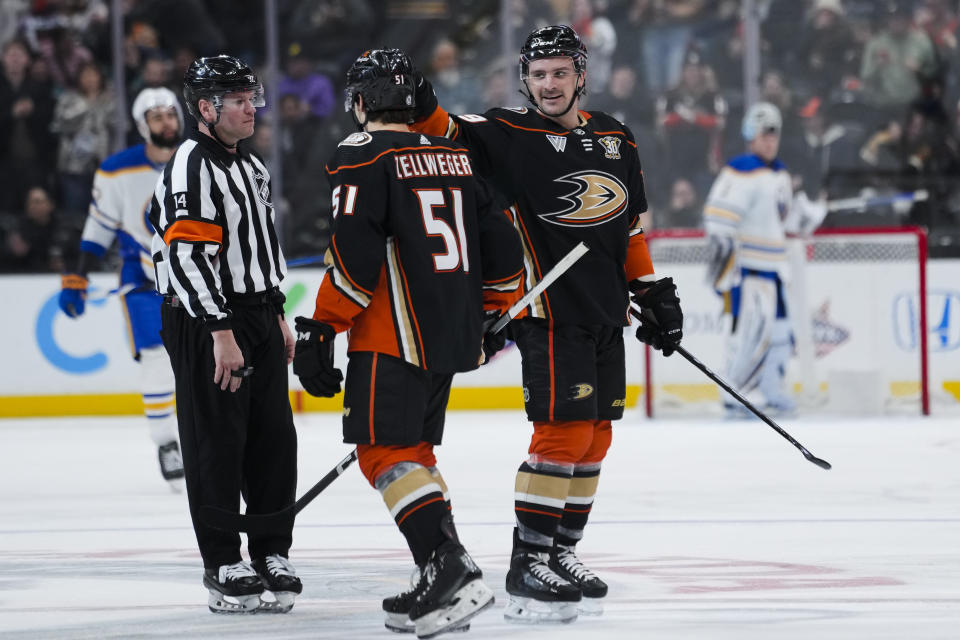 Anaheim Ducks center Sam Carrick, right, celebrates with defenseman Olen Zellweger after scoring during the second period of an NHL hockey game Tuesday, Jan. 23, 2024, in Anaheim, Calif. (AP Photo/Ryan Sun)