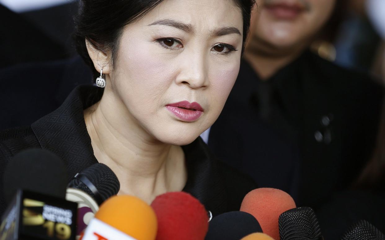 Former Thai Prime Minister Yingluck Shinawatra speaks to the media after she arrives for her trial - EPA