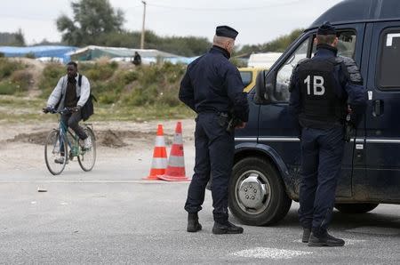 French Gendarmes stand outside the "Jungle", a migrant camp in Calais, France, October 12, 2016. REUTERS/Pascal Rossignol