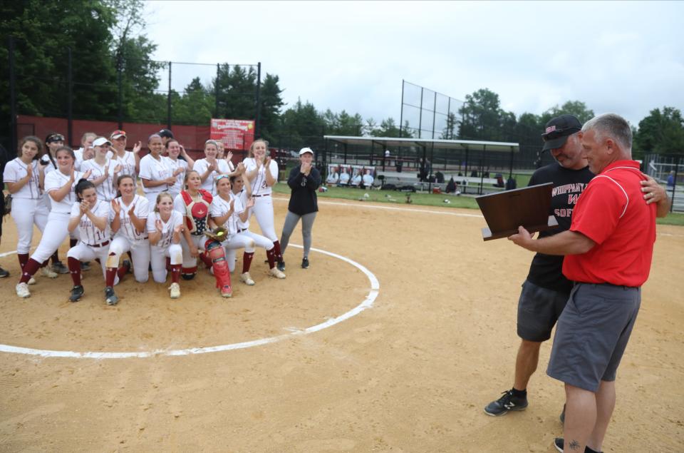 Whippany Park head coach Todd Callaghan receives the championship trophy from athletic director Brent Kaiser. The Wildcats won the North 2, Group 1 softball final, 7-0 over Becton, in a game played at Whippany Park on June 12, 2021.