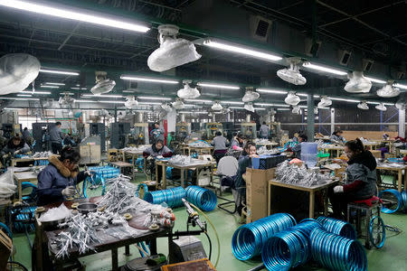 Employees work on the production line of Kent bicycles at Shanghai General Sports Co., Ltd, in Kunshan, Jiangsu Province, China, February 22, 2019. Picture taken February 22, 2019. REUTERS/Aly Song