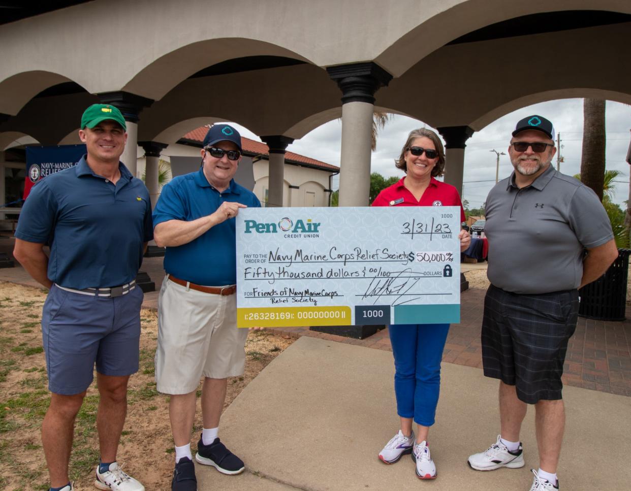 The Navy Marine-Corps. Relief Society scores $50,000 from the 23rd annual Charity Golf Tournament and Pen Air Credit Union.