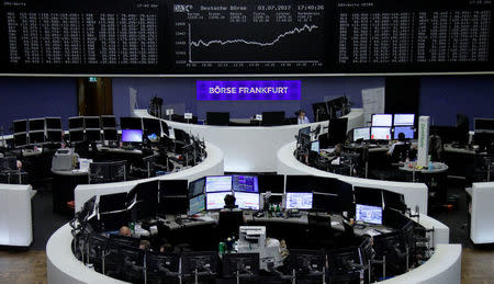 Traders work in front of the German share price index, DAX board, at the stock exchange in Frankfurt, Germany, July 3, 2017. REUTERS/Staff/Remote