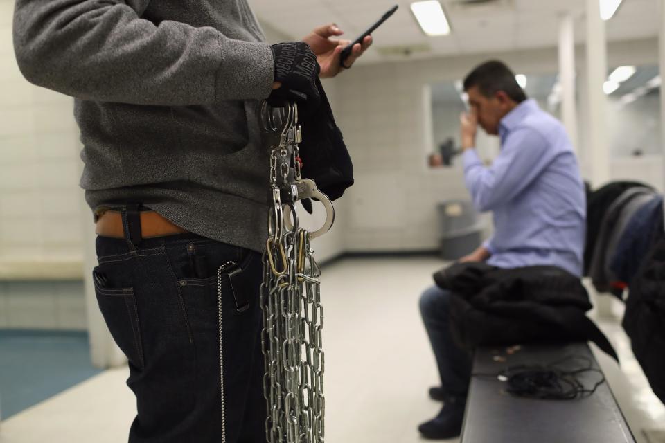 An Immigration and Customs Enforcement (ICE) officer carries shackles for undocumented immigrants inside an ICE processing center on April 11, 2018 at the U.S. Federal Building in lower Manhattan, New York City.