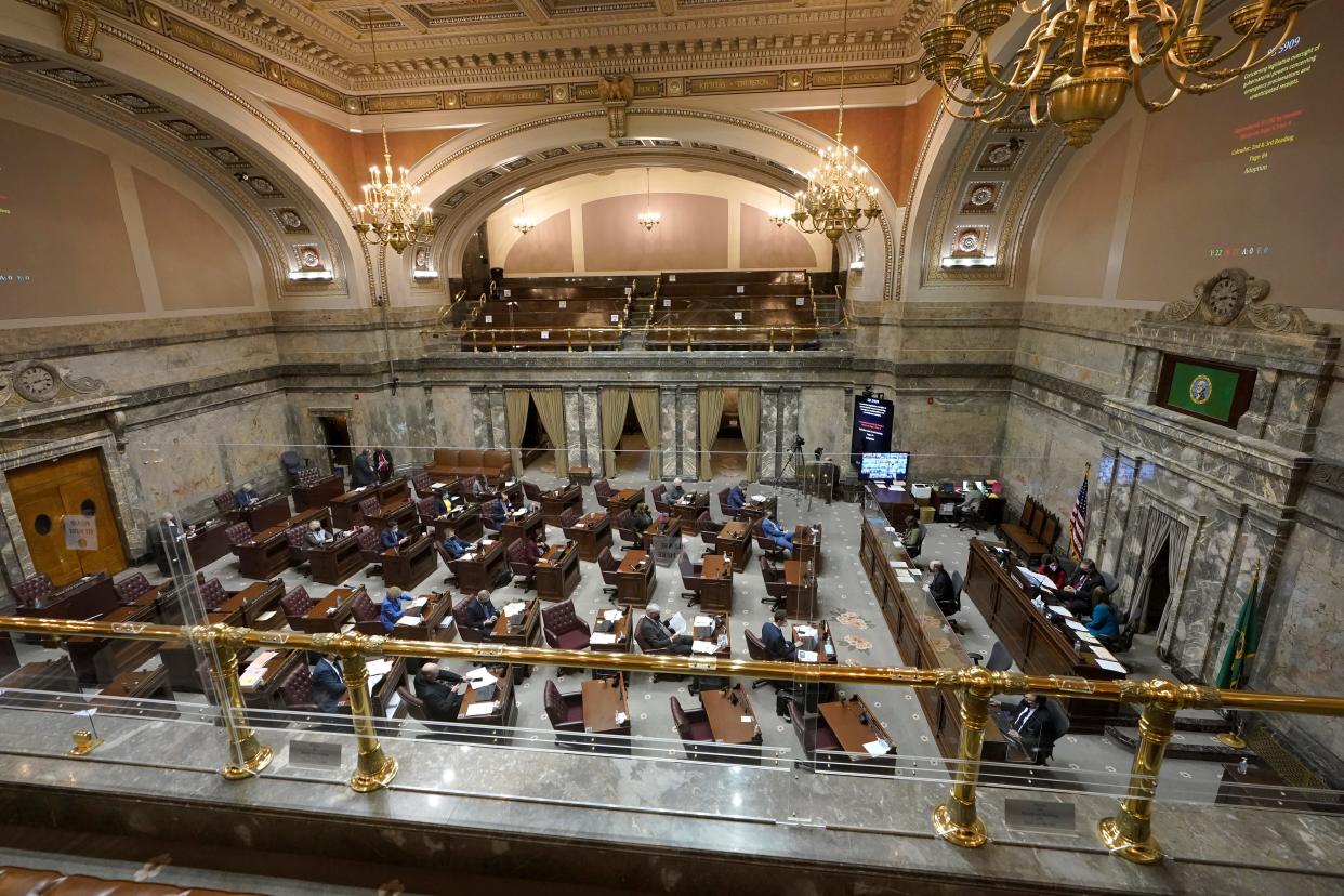 FILE ⁠— Legislators work on the Washington Senate floor at the Capitol in Olympia in February.