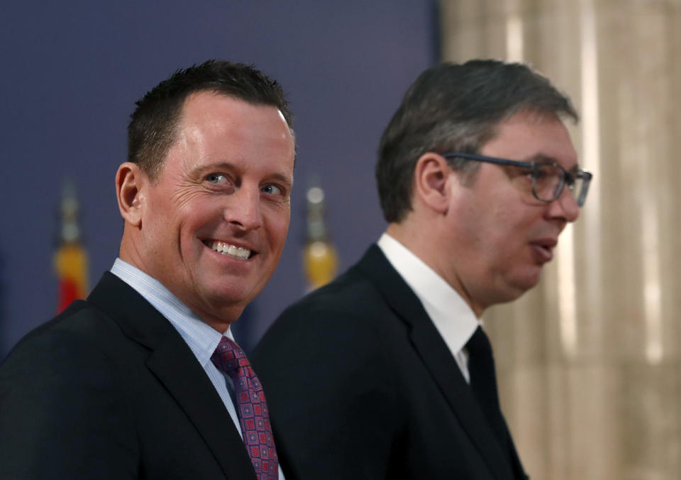 U.S. President Donald Trump's envoy for the Kosovo-Serbia dialogue, Ambassador Richard Grenell, left, and Serbian President Aleksandar Vucic arrive for a news conference after their meeting in Belgrade, Serbia, Friday, Jan. 24, 2020. Grenell is meeting Serbian President Vucic in order to move the dialogue and normalize relations between the two sides.(AP Photo/Darko Vojinovic)