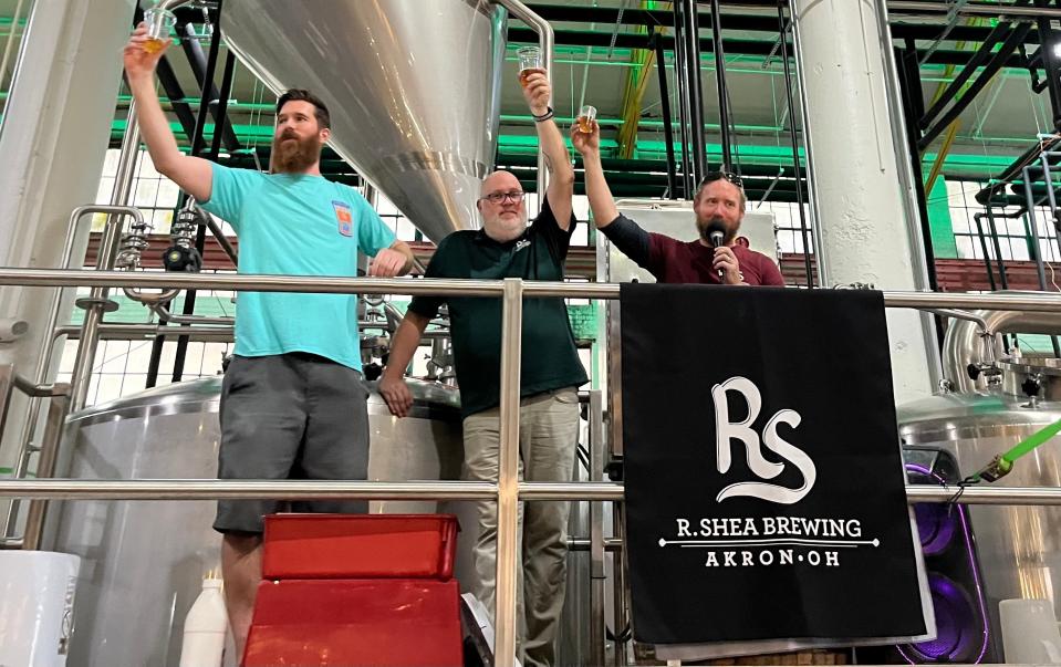 Ron Shea (right) toasts the kick-off of a business-saving fundraiser campaign with his head of sales, Matt Cern (middle), and general manager, Justin Schwarz, Sunday at the production brewery in Akron's Canal Place.