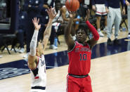 St. John's forward Marcellus Earlington (10) scores against Connecticut guard Tyrese Martin (4) in the second half of an NCAA college basketball game in Storrs, Conn., Monday, Jan. 18, 2021. (David Butler II/Pool Photo via AP)