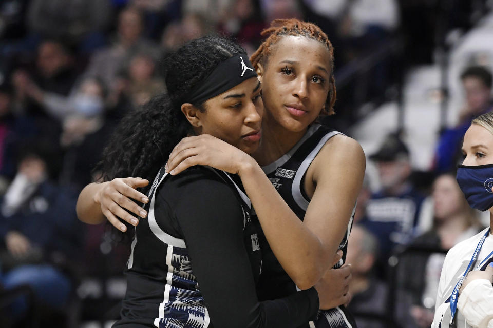 Georgetown's Milan Bolden-Morris, left, and Jillian Archer, embrace near the end of the second half of an NCAA college basketball game against Connecticut in the quarterfinals of the Big East Conference tournament at Mohegan Sun Arena, Saturday, March 5, 2022, in Uncasville, Conn. (AP Photo/Jessica Hill)
